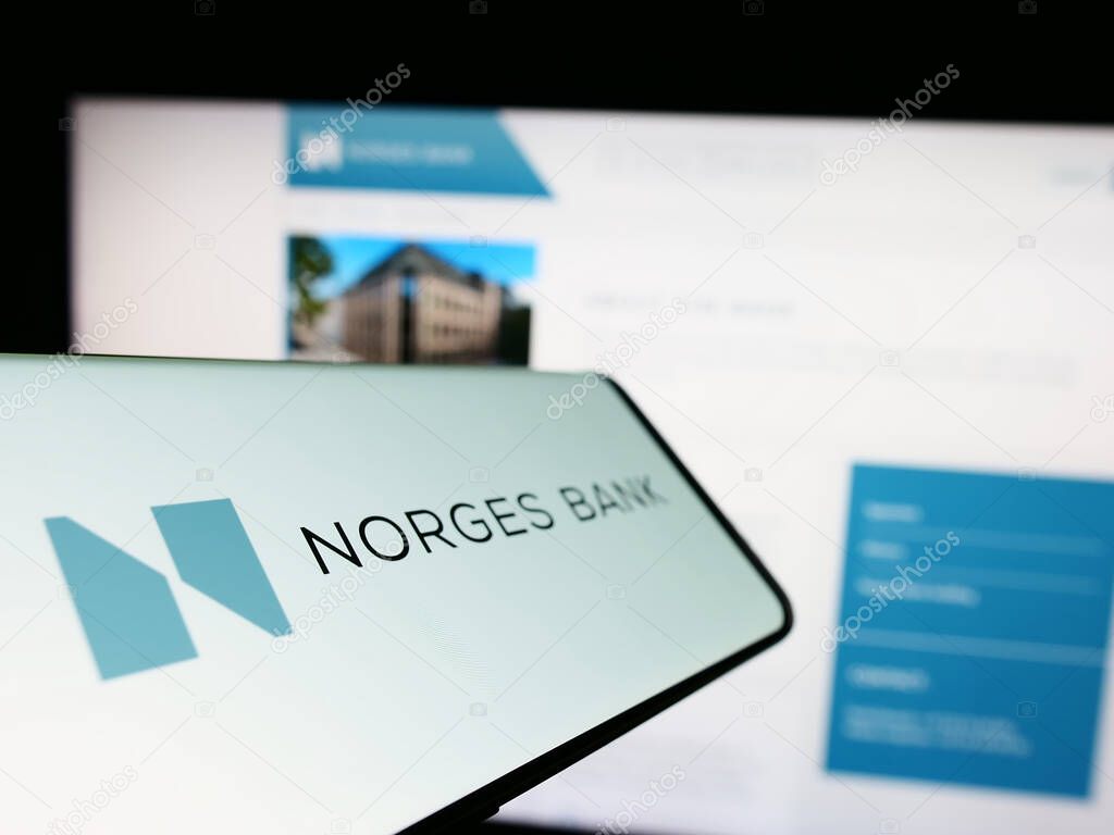 Stuttgart, Germany - 04-02-2023: Smartphone with logo of Norwegian central bank Norges Bank on screen in front of website. Focus on center-left of phone display.