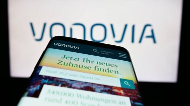 Stuttgart, Almanya - 04-04-2023: Alman emlak şirketi Vonovia SE 'nin web sitesi olan cep telefonu iş logosu önünde ekranda. Telefon ekranının sol üst kısmına odaklan.