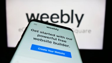 Stuttgart, Almanya - 04-19-2023: Weebly web ev sahipliği şirketinin web sitesi ile birlikte cep telefonu iş logosu önünde ekranda. Telefon ekranının sol üst kısmına odaklan.