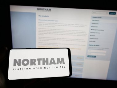 Stuttgart, Almanya - 04-19-2023: Web sitesi önünde Northam Platinum Holding Limited şirketinin logosuna sahip akıllı telefon sahibi kişi. Telefon ekranına odaklan.