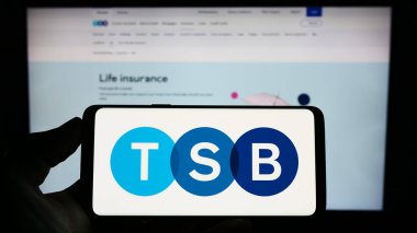 Stuttgart, Germany - 04-20-2023: Person holding cellphone with logo of British financial company TSB Bank plc on screen in front of business webpage. Focus on phone display. clipart