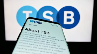 Stuttgart, Germany - 04-20-2023: Mobile phone with website of British financial company TSB Bank plc on screen in front of business logo. Focus on top-left of phone display. clipart