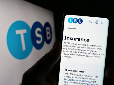 Stuttgart, Germany - 04-20-2023: Person holding cellphone with webpage of British financial company TSB Bank plc on screen in front of logo. Focus on center of phone display. clipart