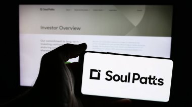 Stuttgart, Almanya - 01-14-2025: Avustralyalı yatırım şirketi Soul Patts 'in logosuyla cep telefonu sahibi olan kişi iş sayfasının önünde ekranda. Telefon ekranına odaklan.