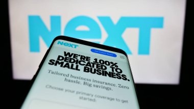 Stuttgart, Almanya - 03-30-2023: ABD 'li finans şirketi Next Sigorta Inc.' in web sitesi ile akıllı telefon, iş logosu önünde ekranda. Telefon ekranının sol üst kısmına odaklan.