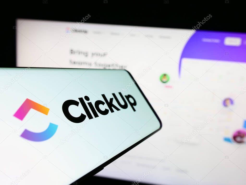 Stuttgart, Germany - 03-30-2023: Smartphone with logo of US company Mango Technologies Inc. (ClickUp) on screen in front of website. Focus on center-left of phone display.