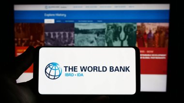 Stuttgart, Almanya - 04-02-2023: Finans kurumu The World Bank 'ın logosunun bulunduğu akıllı telefonu web sitesi önünde tutan kişi. Telefon ekranına odaklan.