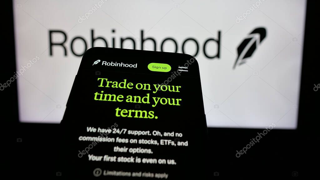 Stuttgart, Germany - 01-15-2025: Mobile phone with website of US financial company Robinhood Markets Inc. on screen in front of business logo. Focus on top-left of phone display.