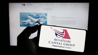 Stuttgart, Almanya - 03-24-2023: Amerikan kiralama şirketi Aviation Capital Group LLC 'nin logosunun bulunduğu cep telefonu web sayfası önünde ekranda. Telefon ekranına odaklan.