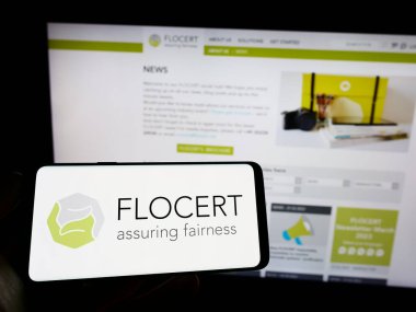 Stuttgart, Almanya - 03-25-2023: Ürün sertifika kurumu FLOCERT GmbH logosu olan cep telefonu web sayfası önünde ekranda. Telefon ekranına odaklan.