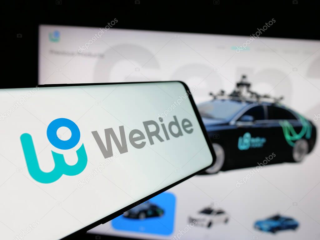 Stuttgart, Germany - 01-23-2025: Smartphone with logo of Chinese autonomous driving company WeRide Inc. on screen in front of website. Focus on center-left of phone display.