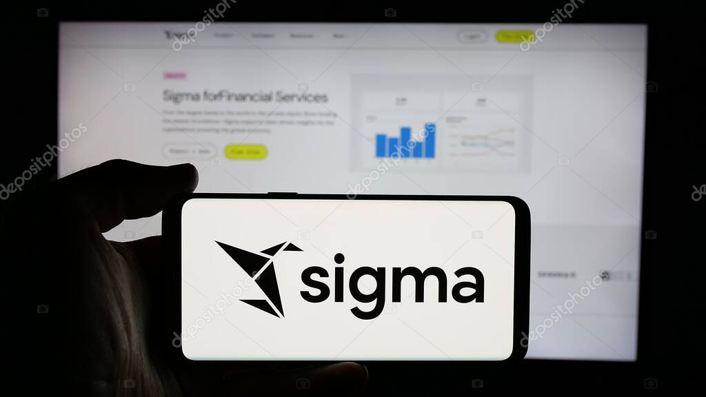 Stuttgart, Germany - 01-28-2025: Person holding cellphone with logo of US analytics software company Sigma Computing Inc. on screen in front of webpage. Focus on phone display.
