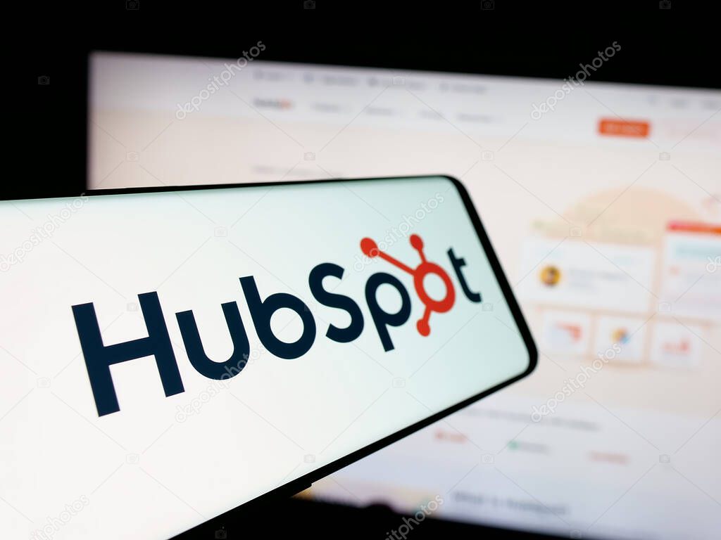 Stuttgart, Germany - 01-28-2025: Cellphone with logo of American marketing software company HubSpot Inc. on screen in front of website. Focus on center-left of phone display.