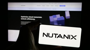 Stuttgart, Almanya - 01-30-2025: İnternet sayfasının önünde ekranda Amerikan bulut bilgisayar şirketi Nutanix Inc. 'in logosuna sahip cep telefonu tutan kişi. Telefon ekranına odaklan.