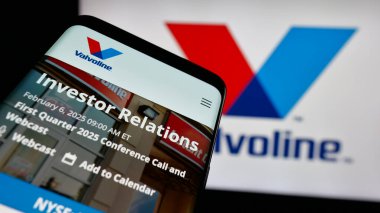 Stuttgart, Germany - 01-31-2025: Mobile phone with logo of US automotive services company Valvoline Inc. on screen in front of business website. Focus on top-left of phone display. clipart