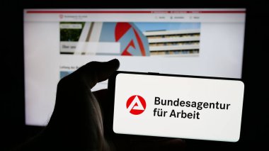 Stuttgart, Almanya - 03-07-2025: Alman federal ajansı Bundesagentur fur Arbeit 'in logosuna sahip cep telefonu web sayfası önünde ekranda. Telefon ekranına odaklan.