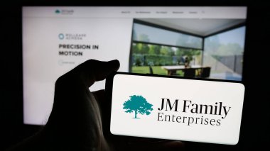 Stuttgart, Almanya - 03-09-2025: ABD 'li şirket JM Family Enterprises Inc.' in logosunun bulunduğu cep telefonu web sayfası önünde ekranda. (JMFE) Telefon ekranına odaklan.