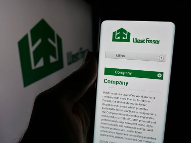 Stuttgart, Almanya - 03-12-2025: Üzerinde orman şirketi West Fraser Timber Co. Ltd. 'nin logosu olan web sayfası logonun önünde duruyor. Telefon ekranının merkezine odaklan.