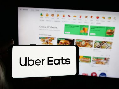 Stuttgart, Almanya - 03-12-2025: ABD 'li çevrimiçi gıda dağıtım şirketi Uber Eats' in logosuna sahip kişi web sitesinin önünde ekranda. Telefon ekranına odaklan.