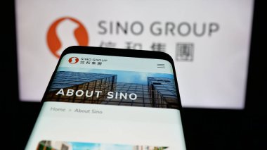 Stuttgart, Almanya - 03-14-2025: Web sitesinin önünde ekranda Hong Kong emlak şirketi Sino Group 'un logosunun olduğu cep telefonu. Telefon ekranının sol üst kısmına odaklan.