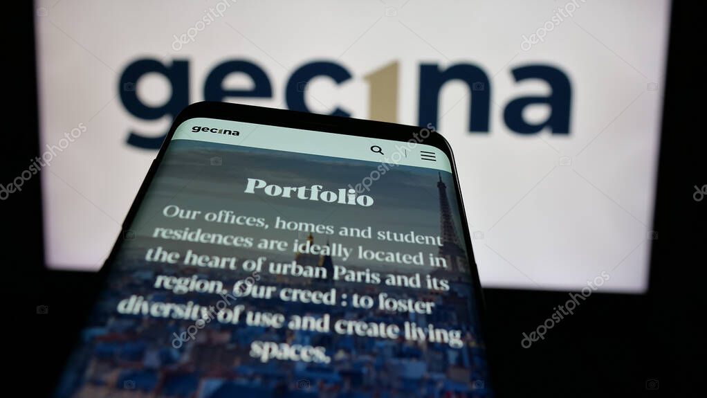 Stuttgart, Germany - 03-14-2025: Mobile phone with logo of French real estate company Gecina S.A. on screen in front of website. Focus on top-left of phone display.
