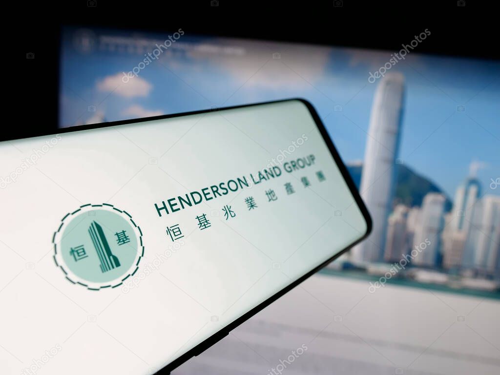 Stuttgart, Germany - 03-14-2025: Smartphone with logo of company Henderson Land Development Co. Ltd. on screen in front of website. Focus on center-left of phone display.