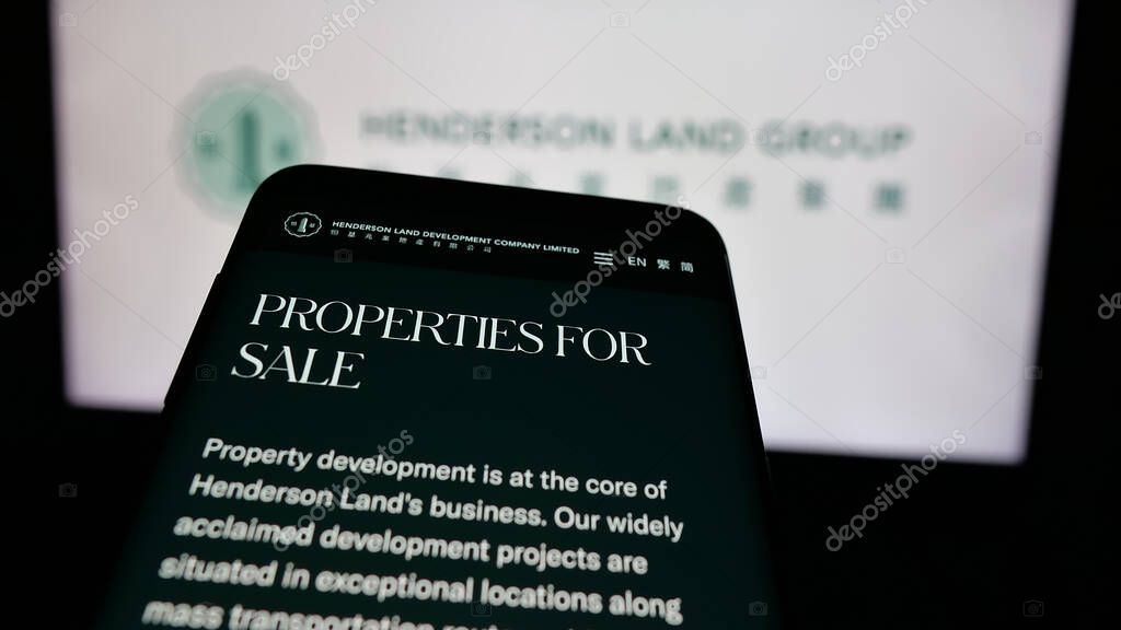 Stuttgart, Germany - 03-14-2025: Mobile phone with logo of company Henderson Land Development Co. Ltd. on screen in front of website. Focus on top-left of phone display.