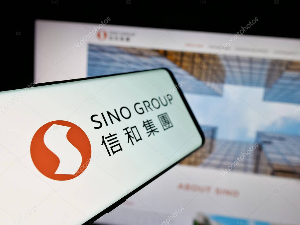 Stuttgart, Germany - 03-14-2025: Smartphone with logo of Hong Kong real estate company Sino Group on screen in front of website. Focus on center-left of phone display.
