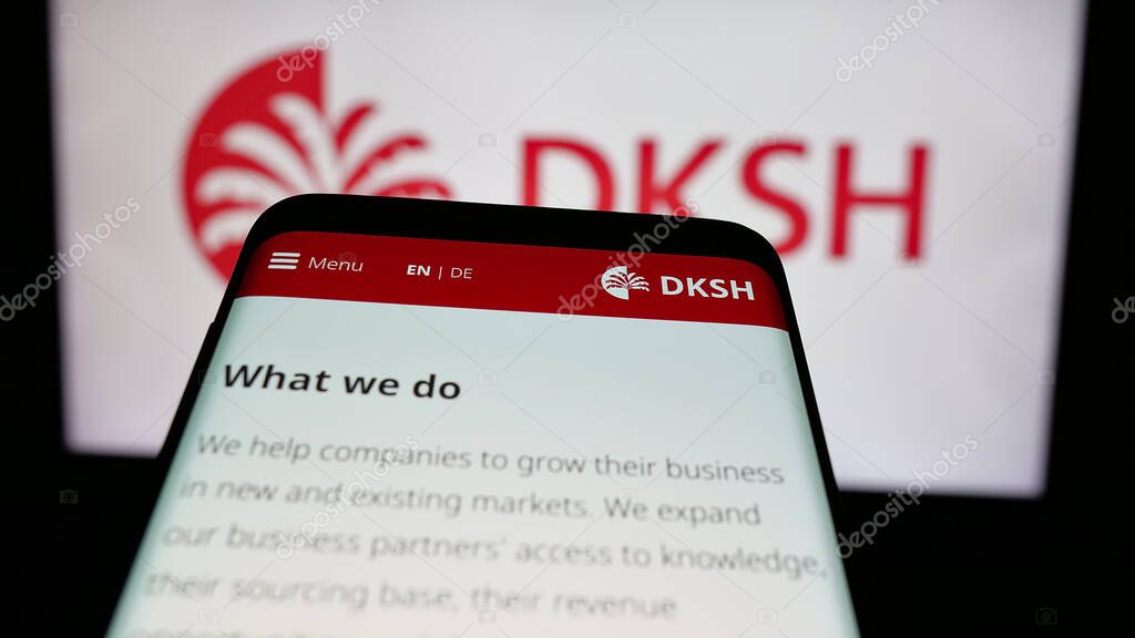 Stuttgart, Germany - 03-19-2025: Mobile phone with logo of Swiss outsourcing company DKSH Holding AG on screen in front of website. Focus on top-left of phone display.