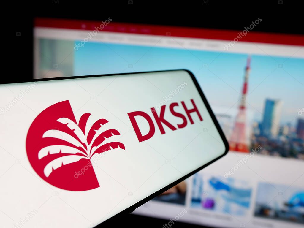 Stuttgart, Germany - 03-19-2025: Smartphone with logo of Swiss outsourcing company DKSH Holding AG on screen in front of website. Focus on center-left of phone display.