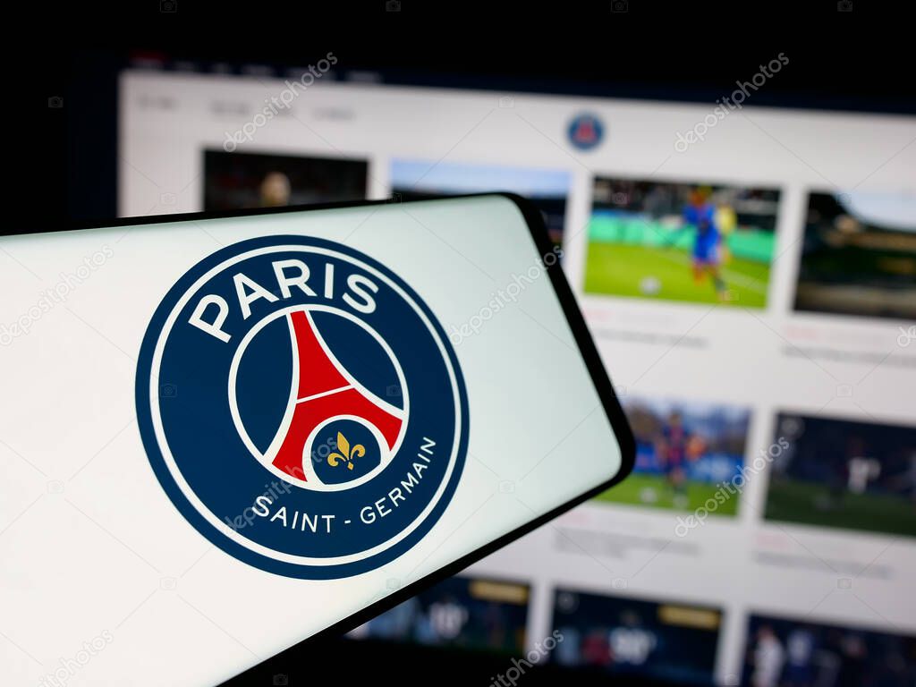 Stuttgart, Germany - 03-21-2025: Smartphone with logo of Paris Saint-Germain Football Club (PSG) on screen in front of website. Focus on center of phone display.