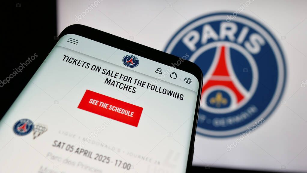 Stuttgart, Germany - 03-21-2025: Mobile phone with logo of Paris Saint-Germain Football Club (PSG) on screen in front of website. Focus on top-left of phone display.