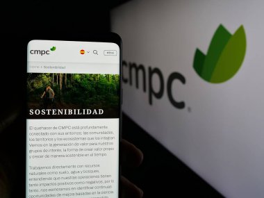 Stuttgart, Almanya - 04-03-2025: Şili 'li kağıt şirketi Empresas CMPC S.A.' nın internet sayfası ile cep telefonu tutan kişi logonun önünde ekranda. Telefon ekranının merkezine odaklan.