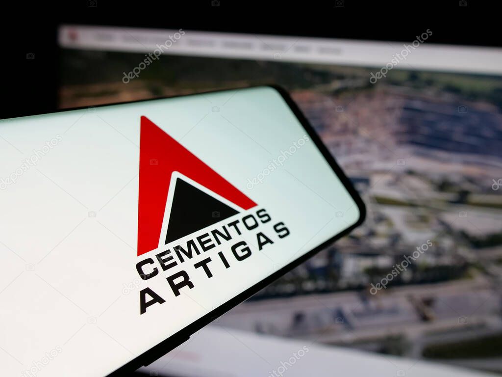 Stuttgart, Germany - 04-02-2025: Smartphone with logo of Uruguayan company Cementos Artigas S.A. on screen in front of website. Focus on center-left of phone display.