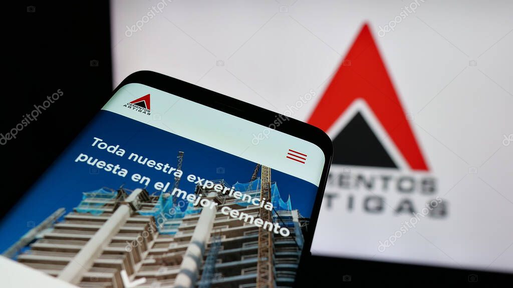 Stuttgart, Germany - 04-02-2025: Mobile phone with logo of Uruguayan company Cementos Artigas S.A. on screen in front of website. Focus on top-left of phone display.