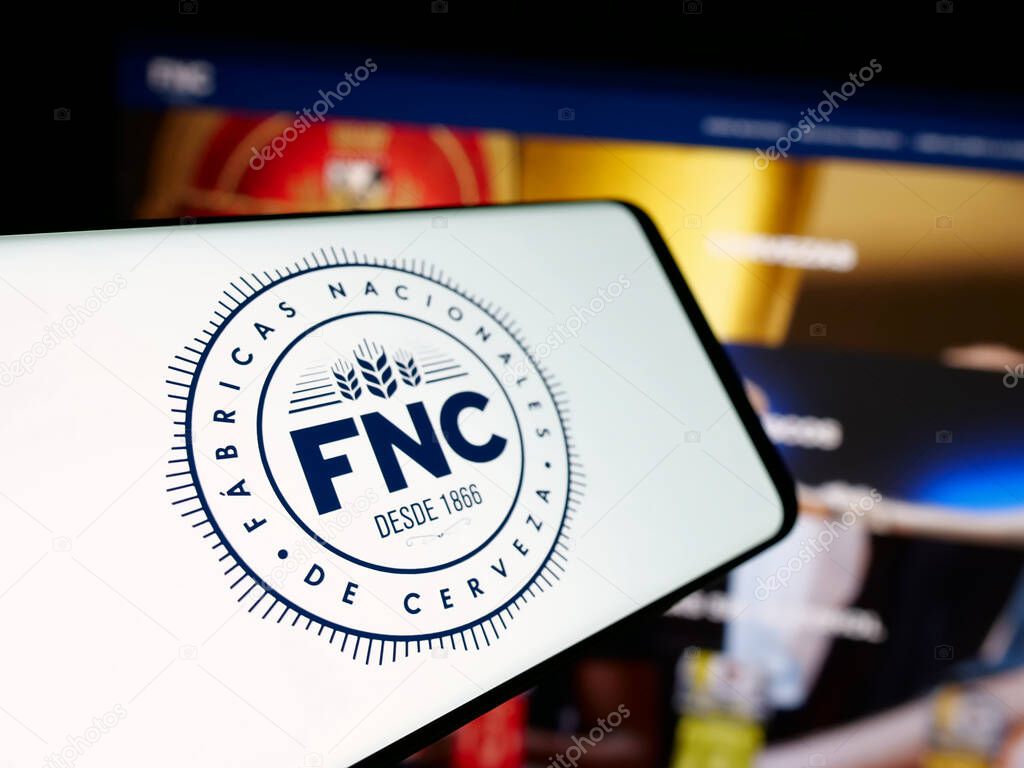Stuttgart, Germany - 04-03-2025: Smartphone with logo of company Fabricas Nacionales de Cerveza (FNC) on screen in front of website. Focus on center-left of phone display.