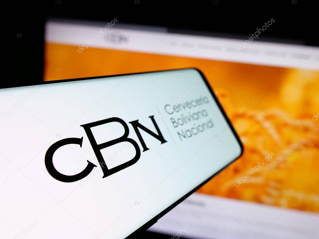Stuttgart, Germany - 04-07-2025: Smartphone with logo of company Cerveceria Boliviana Nacional (CBN) on screen in front of website. Focus on center-left of phone display.