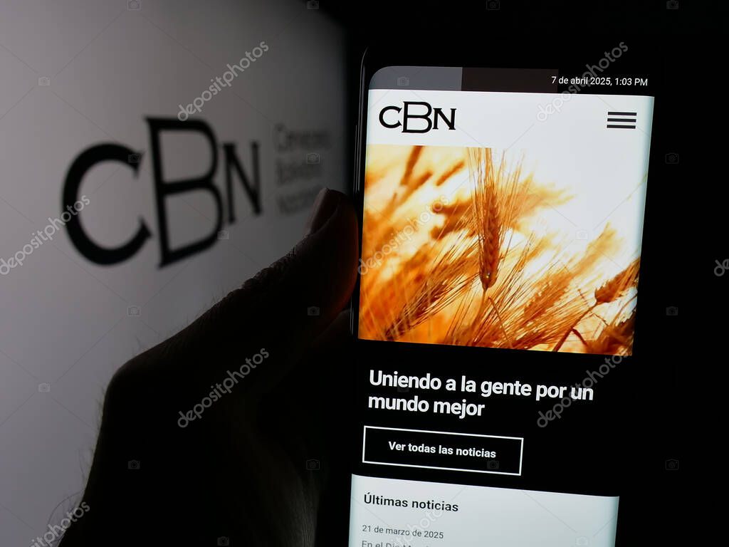 Stuttgart, Germany - 04-07-2025: Person holding web page with logo of company Cerveceria Boliviana Nacional (CBN) on screen in front of logo. Focus on center of phone display.
