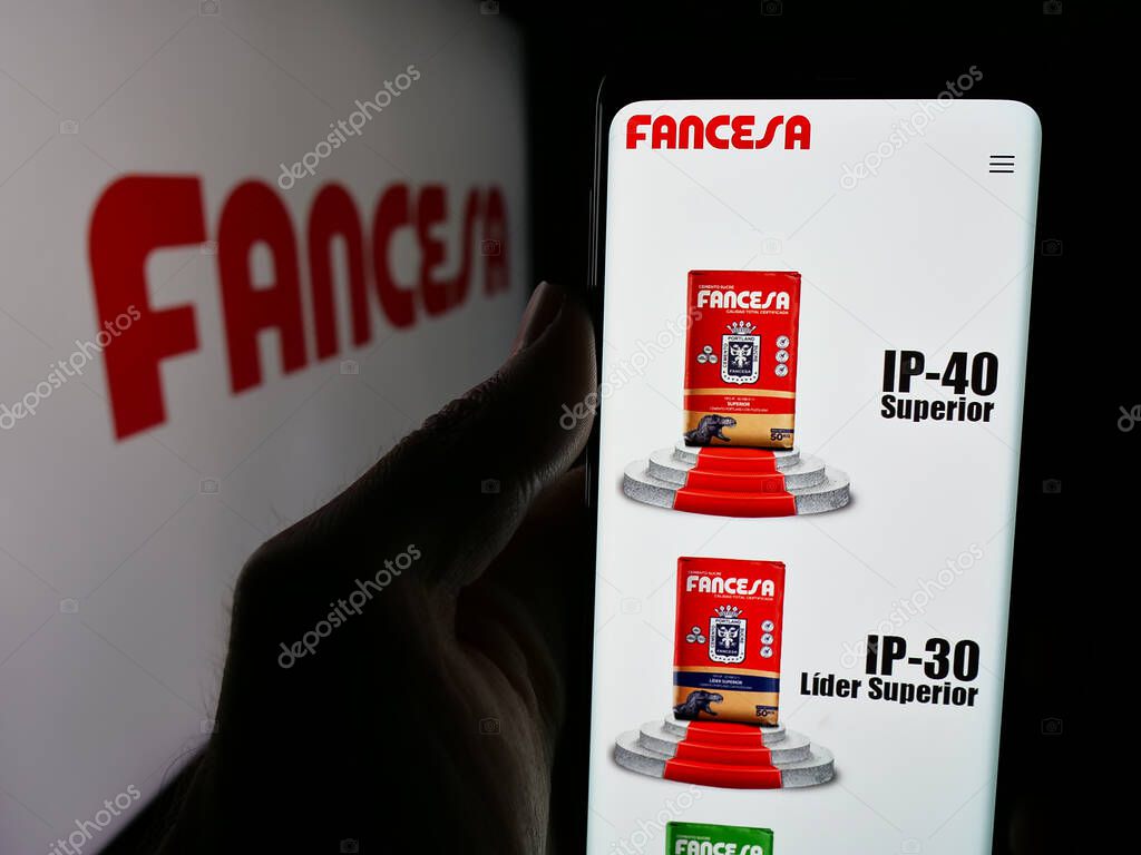 Stuttgart, Germany - 04-09-2025: Person holding web page with logo of company Fabrica Nacional de Cemento (FANCESA) on screen in front of logo. Focus on center of phone display.