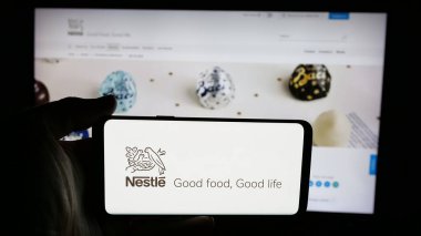 Stuttgart, Almanya - 04-09-2025: Cep telefonunda İsviçre yiyecek ve içecek şirketi Nestle S.A. logosu olan kişi web sayfasının önünde ekranda. Telefon ekranına odaklan.