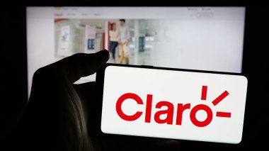 Stuttgart, Almanya - 04-09-2025: İnternet sayfasının önündeki ekranda telekomünikasyon şirketi Claro Ecuado 'nun logosunun bulunduğu cep telefonu sahibi kişi. Telefon ekranına odaklan.