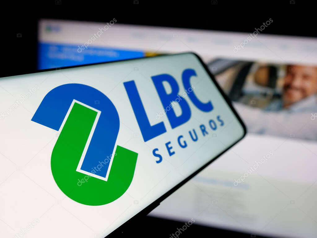 Stuttgart, Germany - 04-09-2025: Smartphone with logo of Bolivian insurance company LBC Seguros on screen in front of website. Focus on left of phone display.