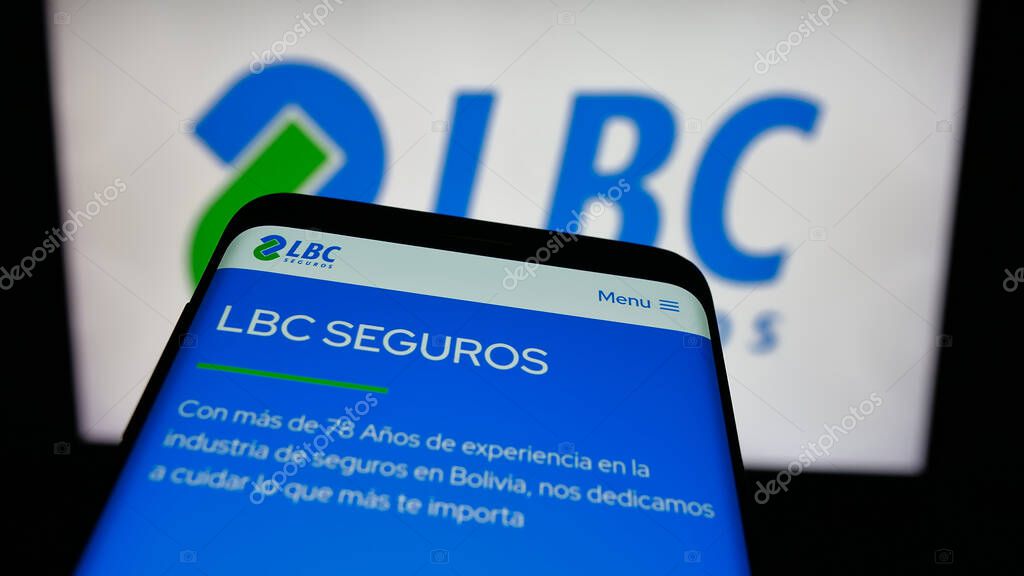 Stuttgart, Germany - 04-09-2025: Mobile phone with webpage of Bolivian insurance company LBC Seguros on screen in front of logo. Focus on top-left of phone display.
