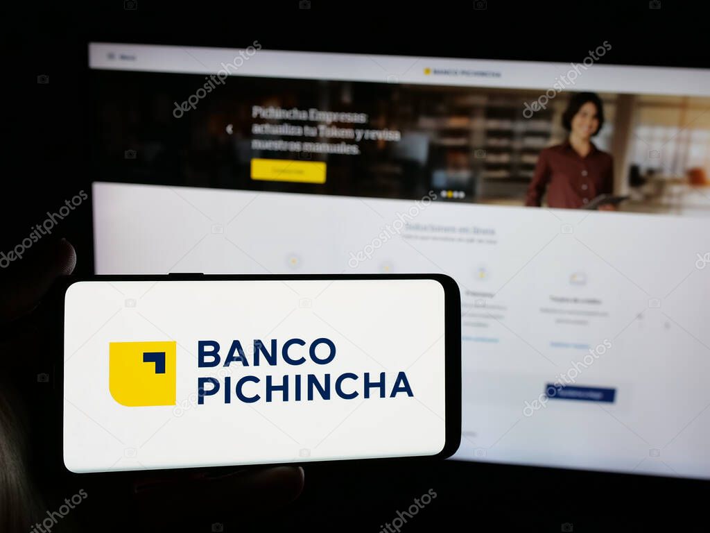 Stuttgart, Germany - 04-09-2025: Person holding smartphone with logo of financial company Banco Pichincha C.A. on screen in front of website. Focus on phone display.