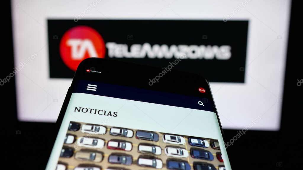 Stuttgart, Germany - 04-09-2025: Mobile phone with webpage of Ecuadorian television network Teleamazonas on screen in front of logo. Focus on top-left of phone display.