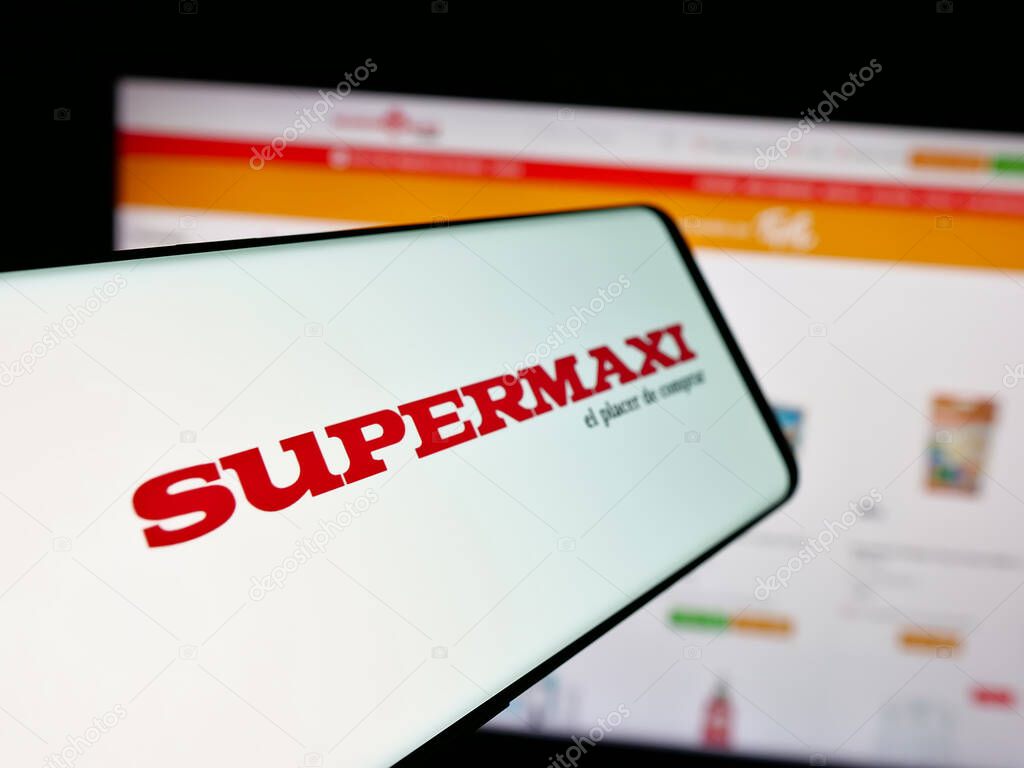Stuttgart, Germany - 04-09-2025: Smartphone with logo of Ecuadorian retail company Supermaxi on screen in front of website. Focus on center-left of phone display.