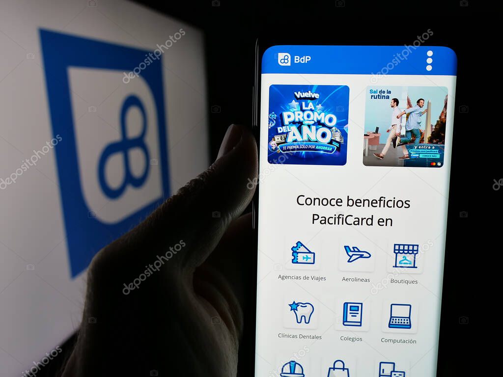 Stuttgart, Germany - 04-09-2025: Person holding smartphone with website of Ecuadorian banking company Banco del Pacifico on screen in front of logo. Focus on center of phone display.