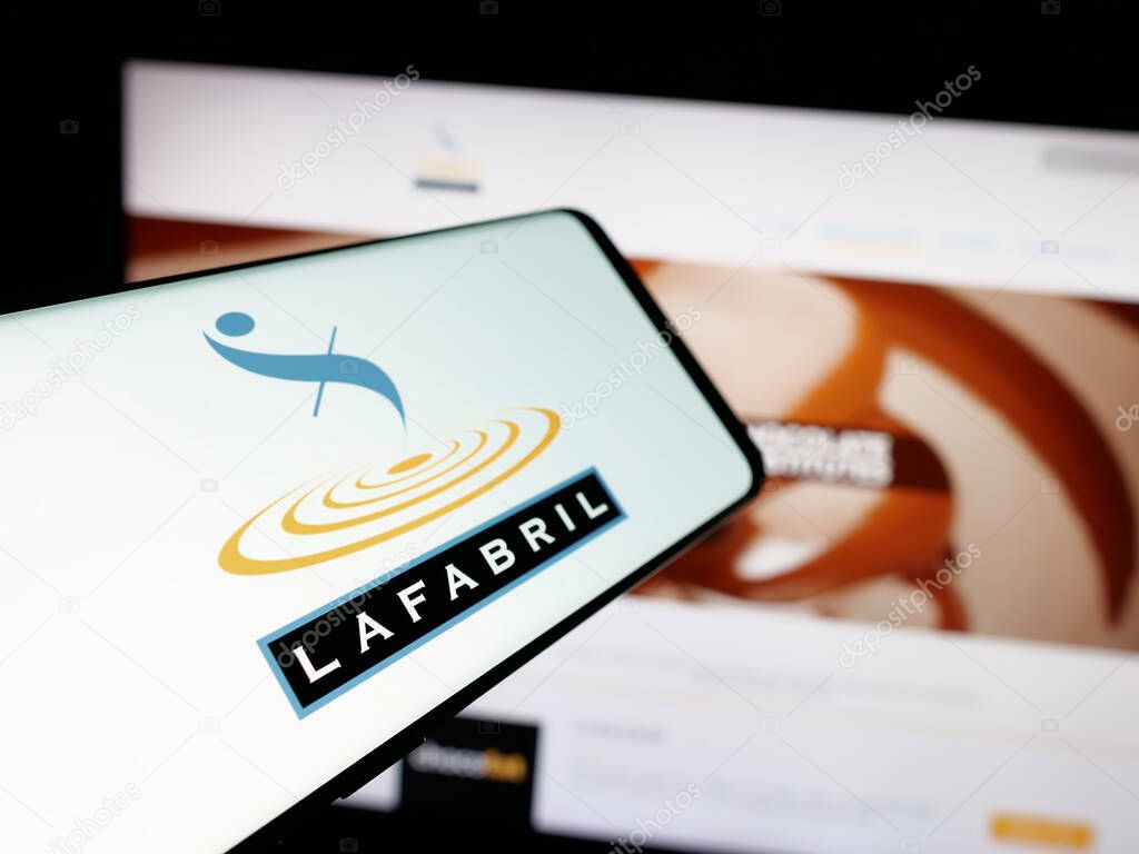 Stuttgart, Germany - 04-09-2025: Smartphone with logo of Ecuadorian food company La Fabril S.A. on screen in front of website. Focus on center-left of phone display.