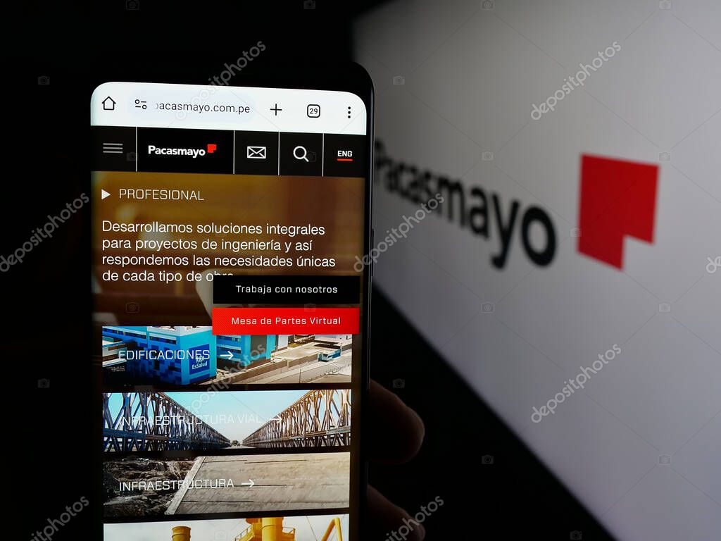 Stuttgart, Germany - 04-09-2025: Person holding cellphone with web page of Peruvian company Cementos Pacasmayo S.A.A. on screen in front of logo. Focus on center of phone display.