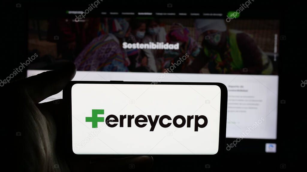 Stuttgart, Germany - 04-17-2025: Person holding cellphone with logo of Peruvian machinery company Ferreycorp S.A.A. on screen in front of webpage. Focus on phone display.